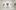 A person stands on a bench in an art gallery, looking at portraits on white walls. Several blurred figures walk around the bright, minimalist space.