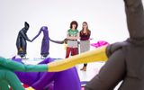 Two adults standing in the middle of a inflatable art installation and admiring the work