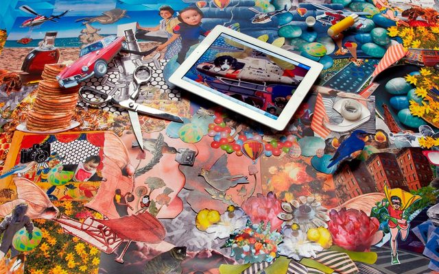 A white electronic tablet with a image of a puppy in toy helicopter, lays on top of a collage of cut out pictures with scissors and tape.