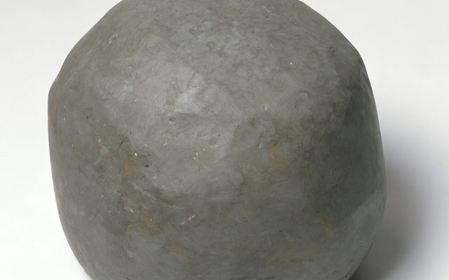 A large grey round stone