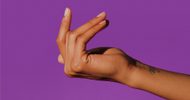 A hand with light brown skin is poised to snap its fingers against a solid purple background. The thumb and middle finger are pressed together, while the index finger is extended upward.