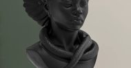 A dark sculpture of a serene woman with closed eyes, hair styled upward, and a snake wrapped around her neck and shoulders, set against a split green and beige background.