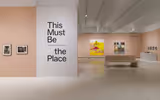 A gallery space with a title on the wall that says: 