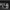Two dancers in white costumes perform on a dark stage, in front of four large panels displaying black-and-white, abstract images of urban and natural scenes.