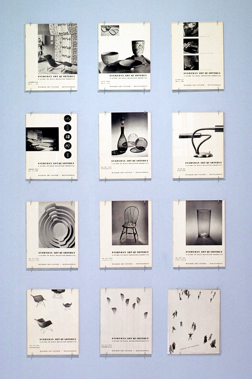 Twelve black-and-white journal covers with images of chairs and other home goods are arranged in a 3 x 4 grid on a light blue wall. Each journal is attached to the wall with clips near the corners.